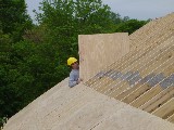 Josh Pitlick lifting a new roof panel.