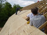 Several people admire the work of future roofing specialist, Steve Tarkington.